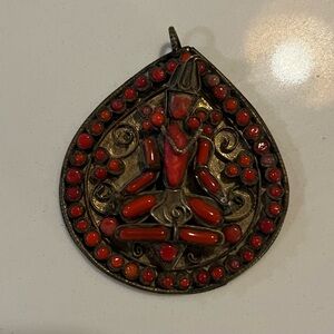 Vintage Tibetan Brass and red coral deity pendant